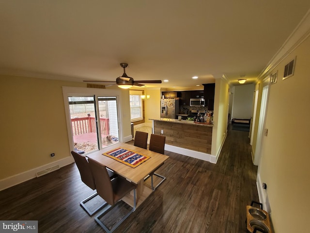 dining room featuring ceiling fan, dark wood-type flooring, and ornamental molding