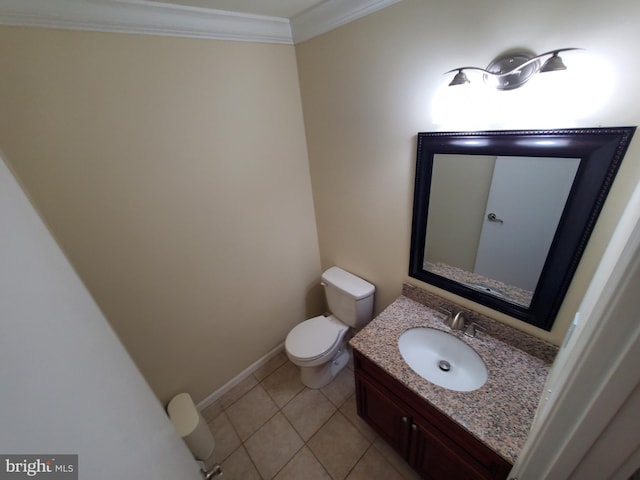 bathroom featuring toilet, vanity, tile patterned floors, and ornamental molding