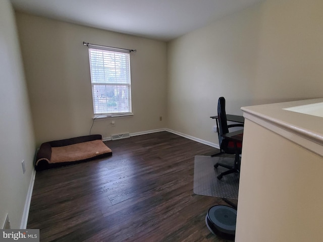 unfurnished office with dark hardwood / wood-style flooring