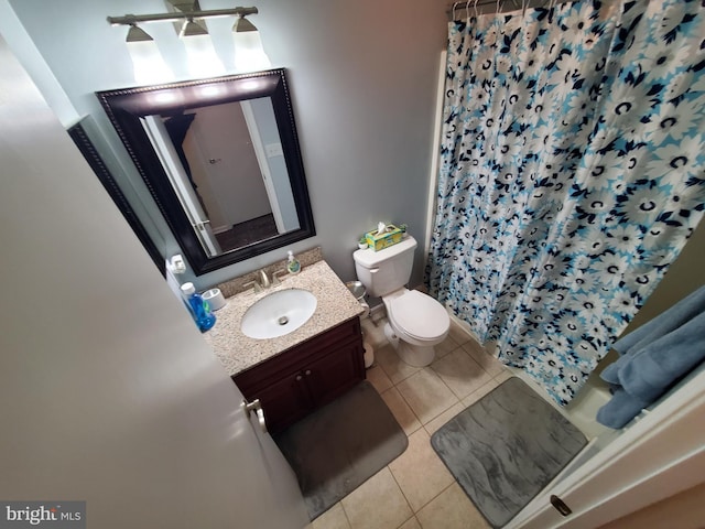 bathroom with a shower with curtain, tile patterned flooring, vanity, and toilet