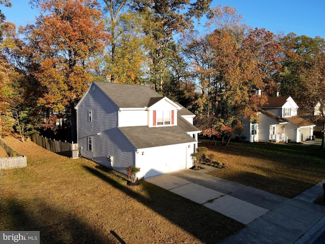 view of side of home with a garage and a yard