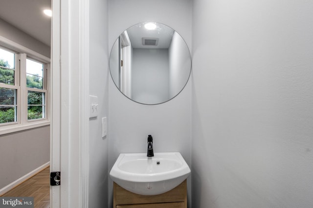 bathroom with vanity and parquet floors