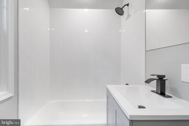 bathroom with vanity and tiled shower / bath combo