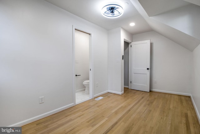 bonus room with light hardwood / wood-style flooring and vaulted ceiling