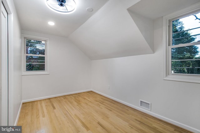 bonus room featuring light hardwood / wood-style floors, ceiling fan, and vaulted ceiling