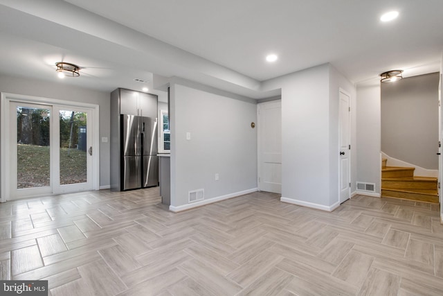 unfurnished room featuring light parquet flooring