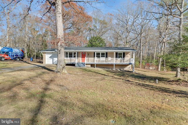 view of front facade featuring covered porch, a garage, and a front yard