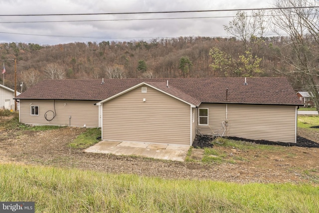 view of side of property featuring a patio area