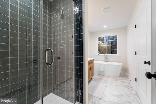 bathroom featuring a freestanding bath, a shower stall, marble finish floor, and vanity