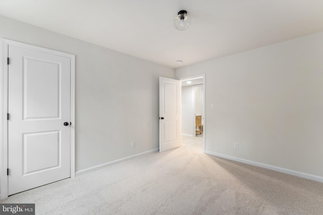 unfurnished bedroom featuring baseboards and carpet flooring