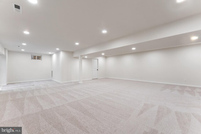 finished basement featuring light carpet, baseboards, visible vents, and recessed lighting
