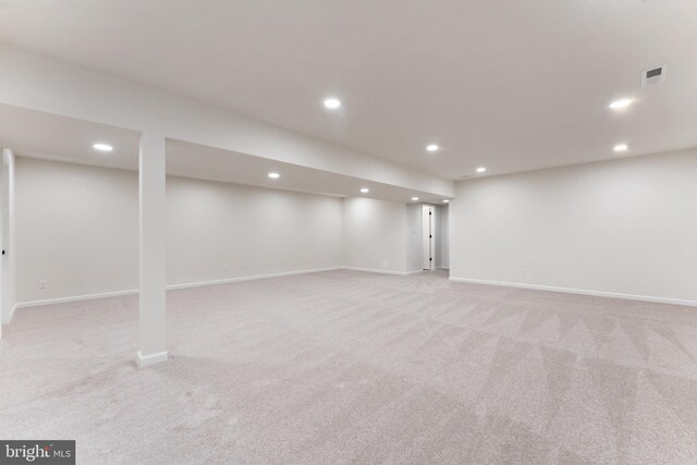 finished basement with visible vents, recessed lighting, and light carpet