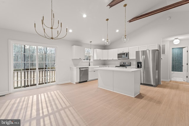 kitchen featuring a healthy amount of sunlight, light wood-type flooring, white cabinetry, and appliances with stainless steel finishes