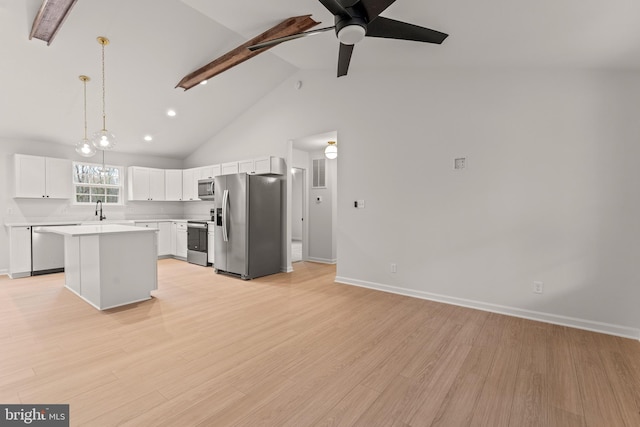 kitchen with stainless steel appliances, pendant lighting, white cabinetry, light hardwood / wood-style flooring, and a kitchen island