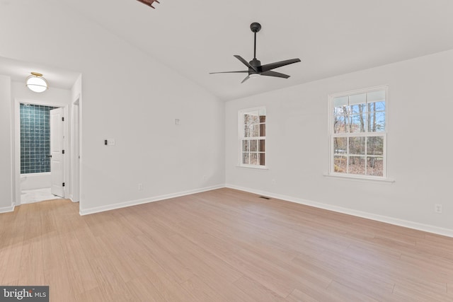 empty room featuring light wood-type flooring, vaulted ceiling, and ceiling fan