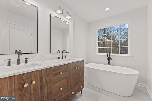 bathroom with vanity, tile patterned floors, and a bathing tub