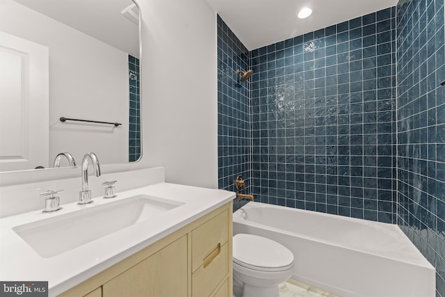 full bathroom with tiled shower / bath combo, toilet, and vanity