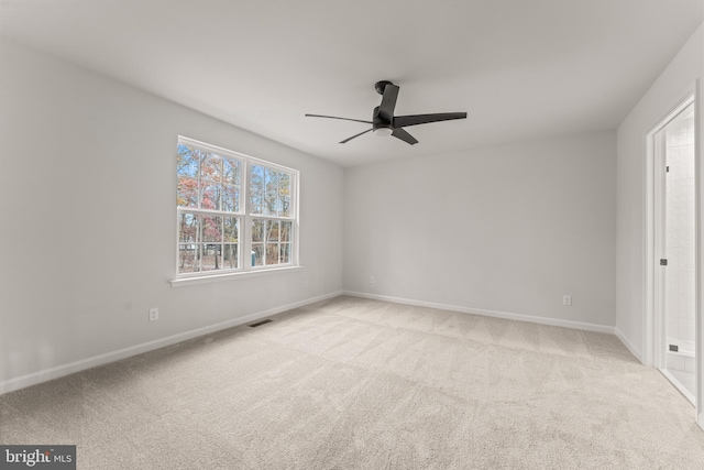 empty room featuring light carpet and ceiling fan