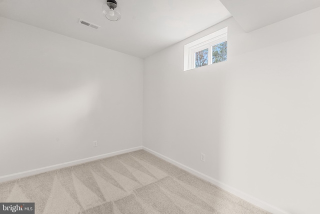 empty room featuring light carpet