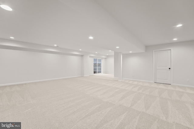 basement featuring light colored carpet