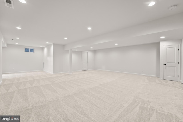 basement featuring light carpet