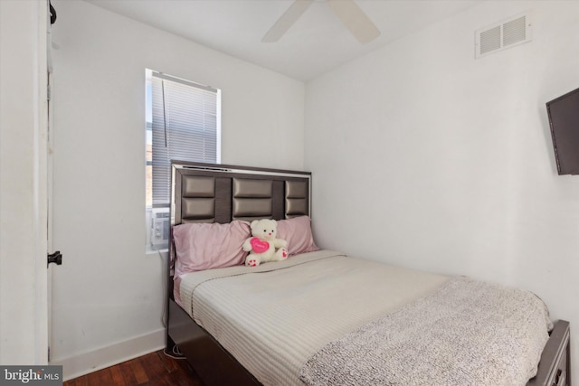 bedroom featuring ceiling fan and dark hardwood / wood-style floors