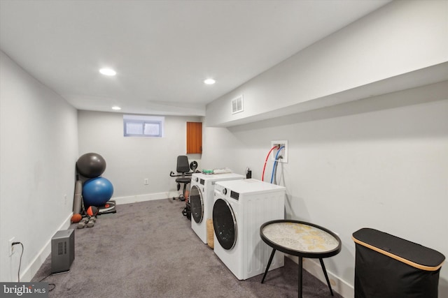 laundry area featuring washer and clothes dryer and light carpet