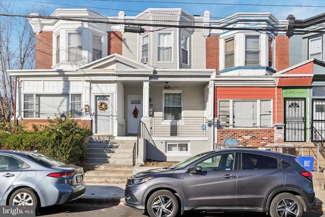 townhome / multi-family property featuring covered porch