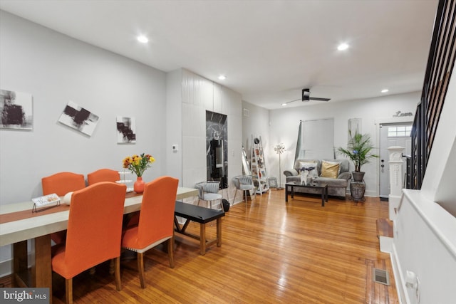 dining space with ceiling fan and light hardwood / wood-style floors