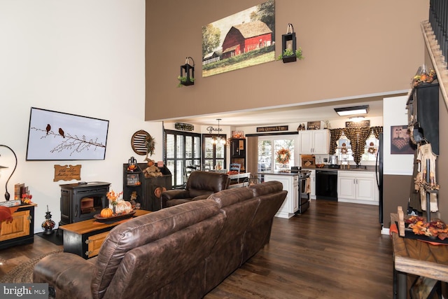 living room featuring dark wood-type flooring and a wood stove