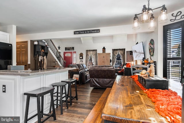 kitchen featuring white cabinets, butcher block counters, dark hardwood / wood-style floors, and hanging light fixtures