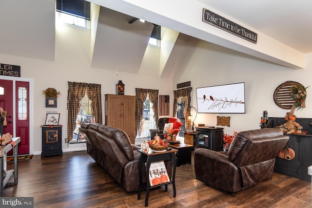 living room featuring a wealth of natural light, dark hardwood / wood-style floors, and a high ceiling