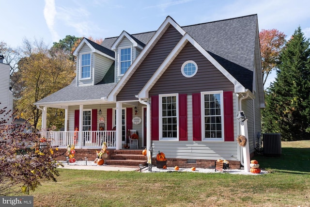 view of front of house featuring a front lawn, central air condition unit, and a porch