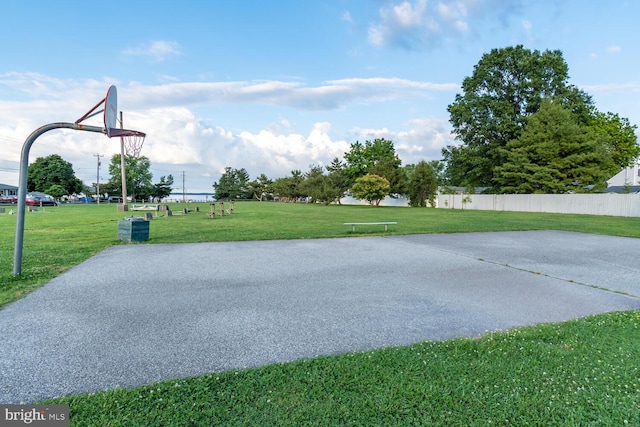 view of sport court featuring a lawn