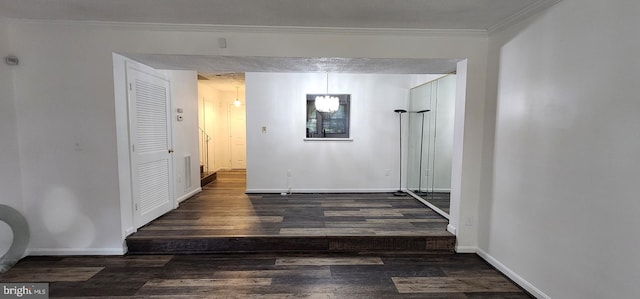 hall with dark wood-type flooring and ornamental molding