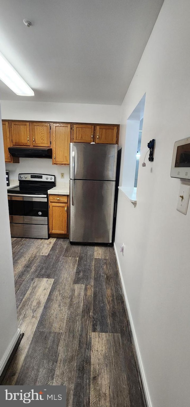 kitchen featuring dark wood-type flooring and stainless steel appliances