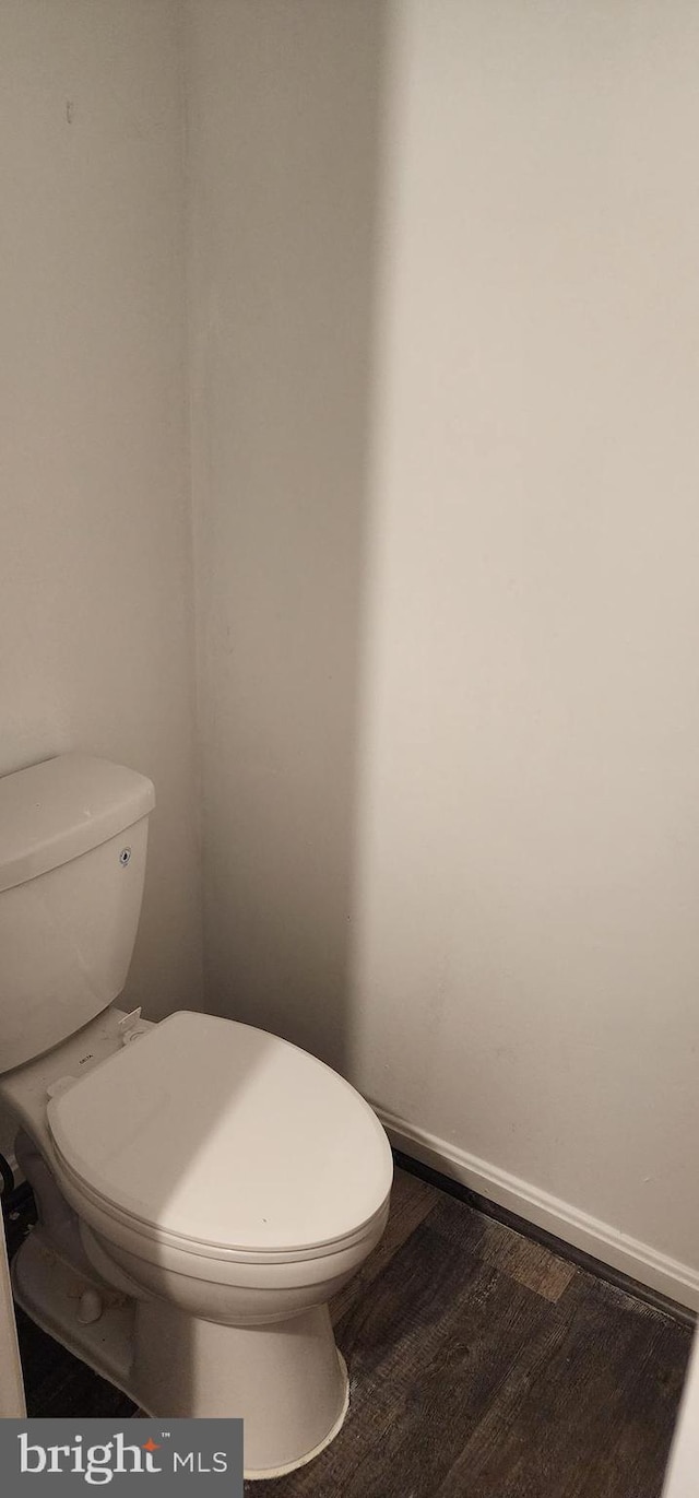 bathroom featuring hardwood / wood-style floors and toilet