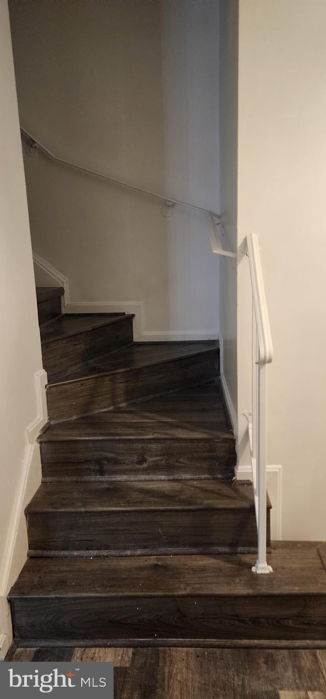 staircase featuring hardwood / wood-style floors