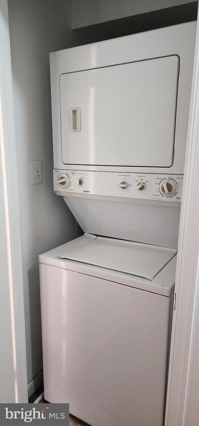 laundry area with stacked washer and dryer