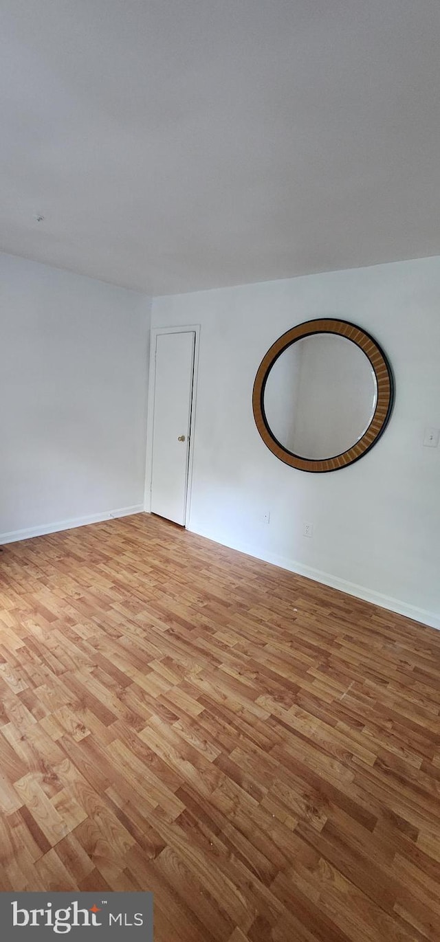 empty room with light hardwood / wood-style flooring