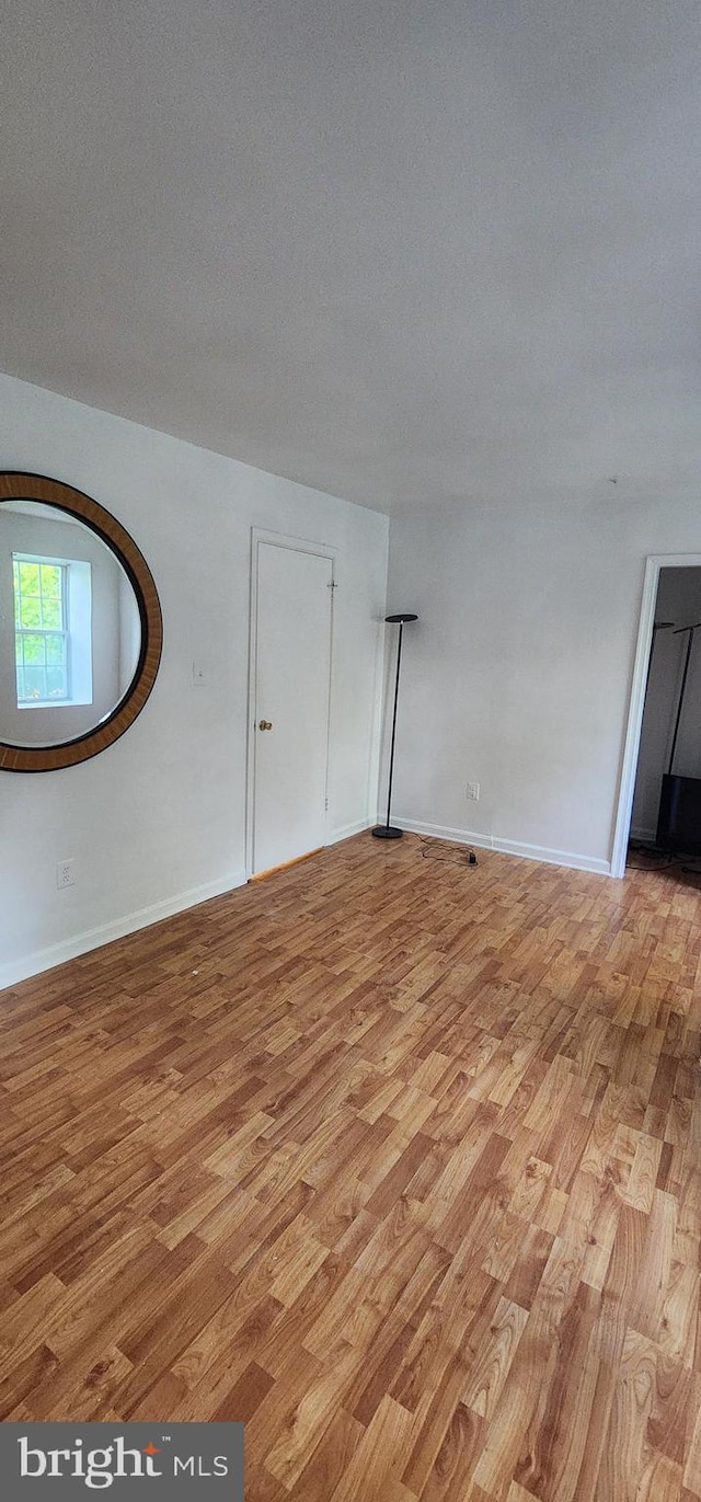 unfurnished room featuring light hardwood / wood-style floors and a textured ceiling