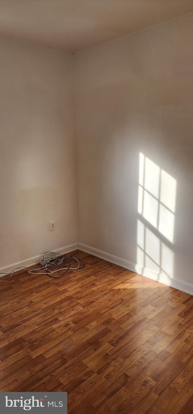 spare room featuring dark wood-type flooring