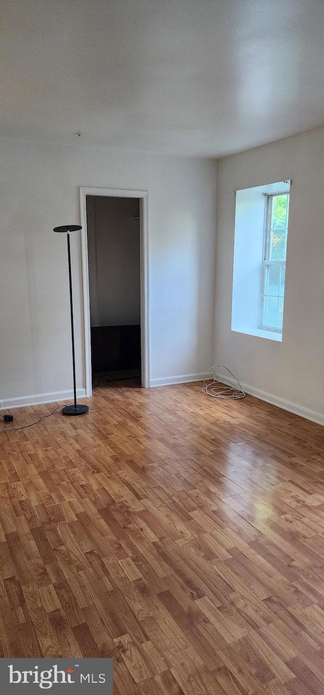 unfurnished room with wood-type flooring