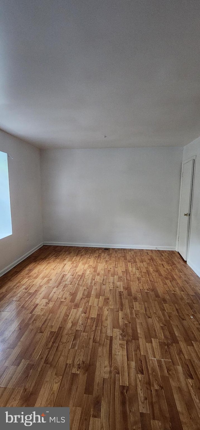 spare room featuring hardwood / wood-style flooring