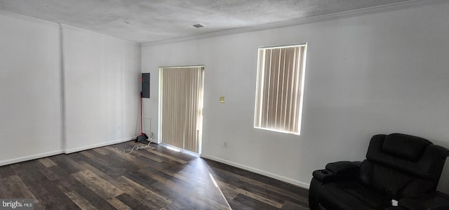 interior space with crown molding, dark hardwood / wood-style flooring, a textured ceiling, and electric panel