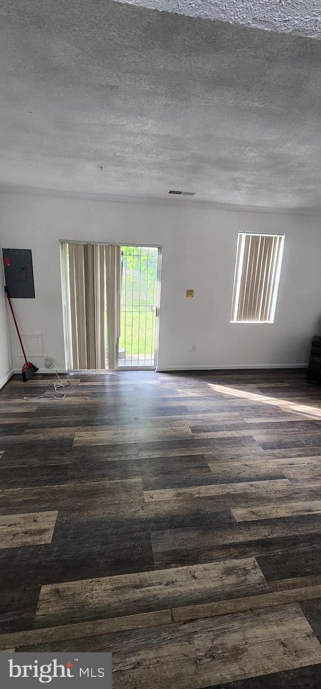 spare room featuring a textured ceiling and electric panel