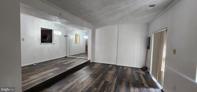 unfurnished room featuring crown molding, dark hardwood / wood-style flooring, and a textured ceiling