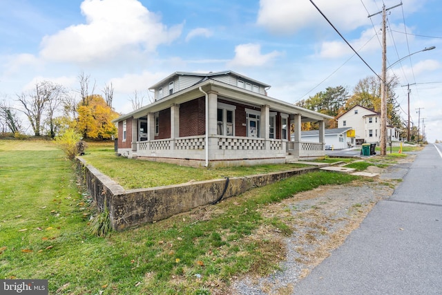 view of home's exterior featuring a lawn and a porch