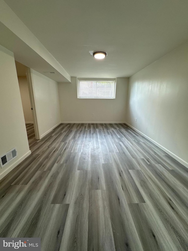 basement with dark hardwood / wood-style flooring