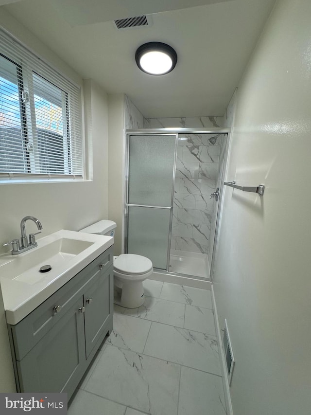 bathroom featuring walk in shower, vanity, and toilet